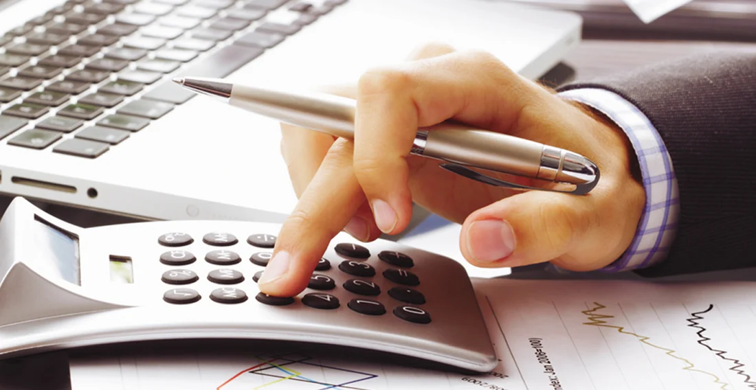 Planning everyday finances with a calculator and paperwork